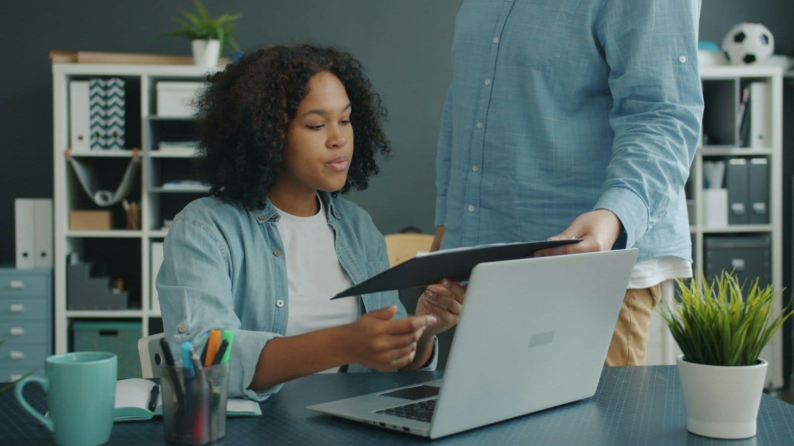 Two colleagues reviewing a document at an office desk